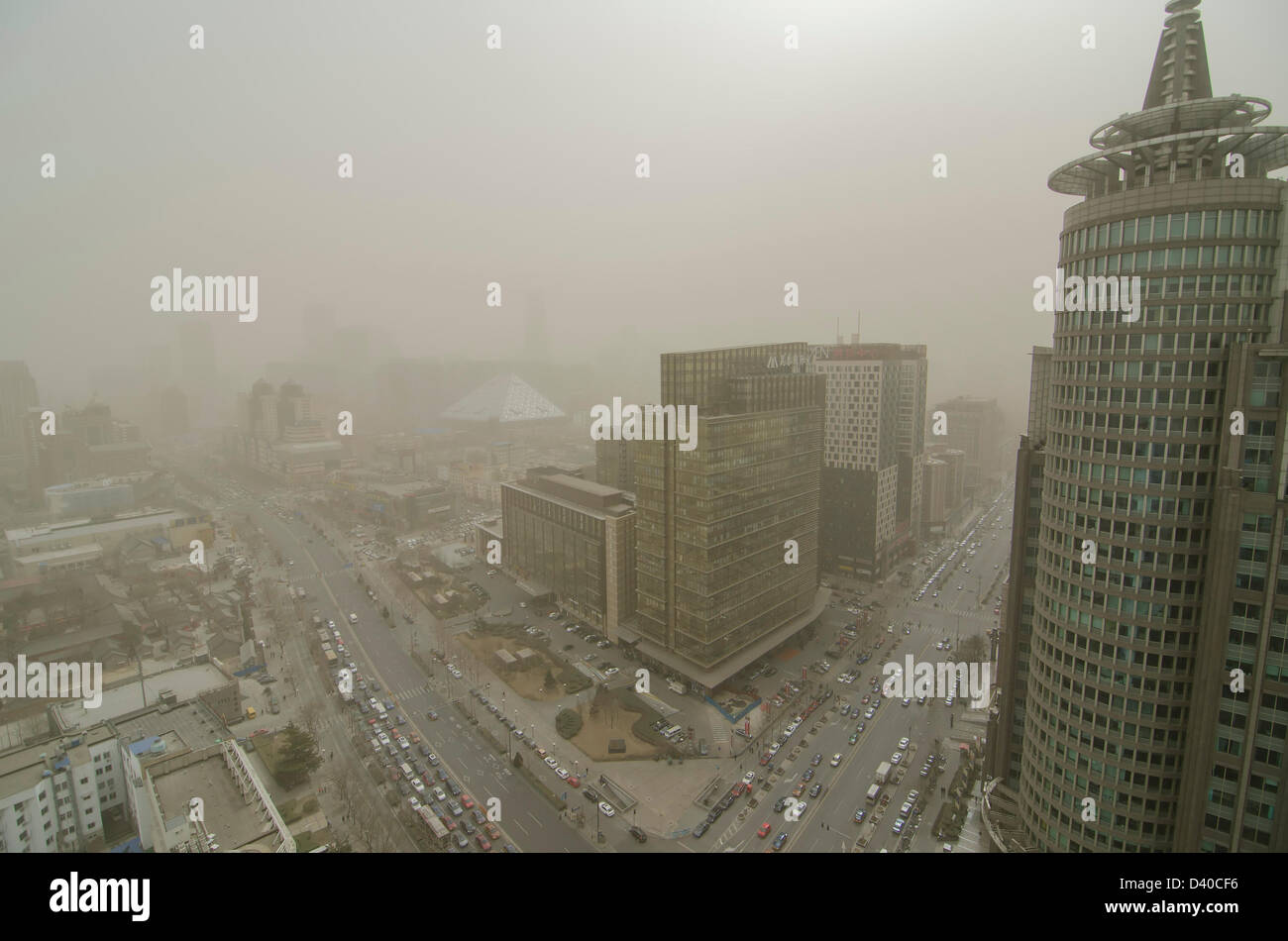 Aerial view across office and residential buildings of the skyline of the Chinese capital city shrouded in smog. Whenever the northerly winds stop, the polluting coal power stations, crop burning and traffic fumes combine, resulting in hazardous air pollution with levels often in excess of 500 on the Air Quality Index, as seen here in the Chaoyang district of Bejiing, China, PRC. © Time-Snaps Stock Photo