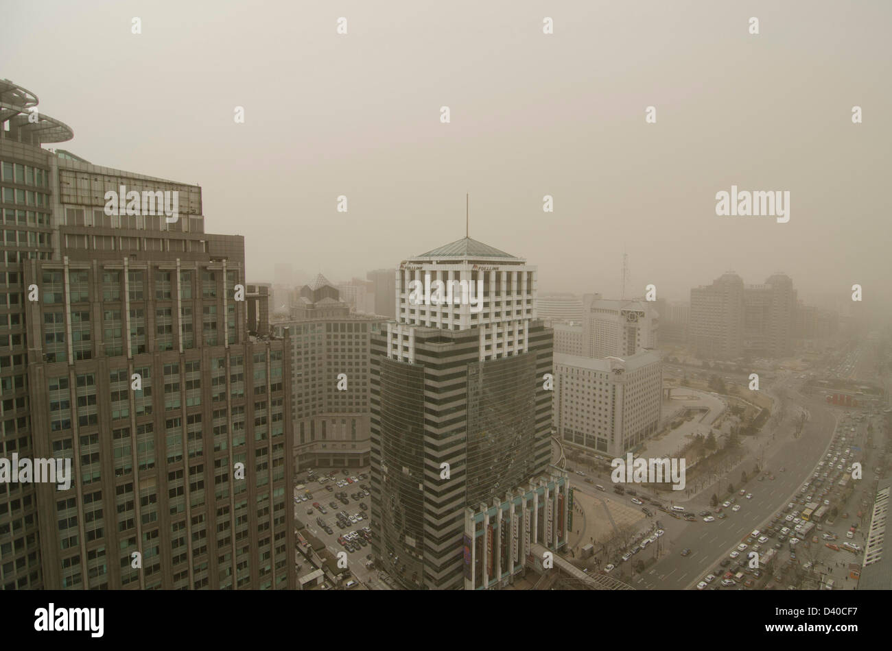 Aerial view across office and residential buildings of the skyline of the Chinese capital city shrouded in smog. Whenever the northerly winds stop, the polluting coal power stations, crop burning and traffic fumes combine, resulting in hazardous air pollution with levels often in excess of 500 on the Air Quality Index, as seen here in the Chaoyang district of Bejiing, China, PRC. © Time-Snaps Stock Photo