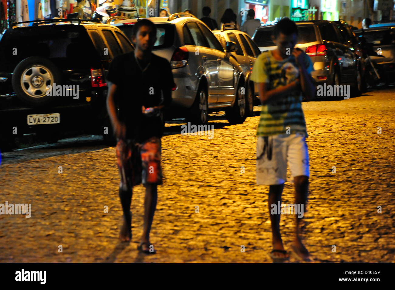 Young men passing the street after the heat of the day Stock Photo