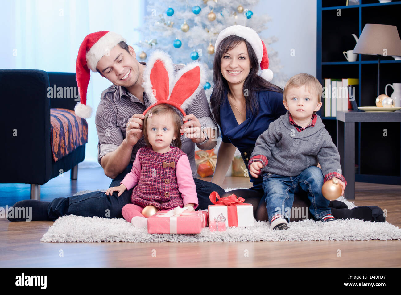 a young family getting Christmas gifts Stock Photo - Alamy