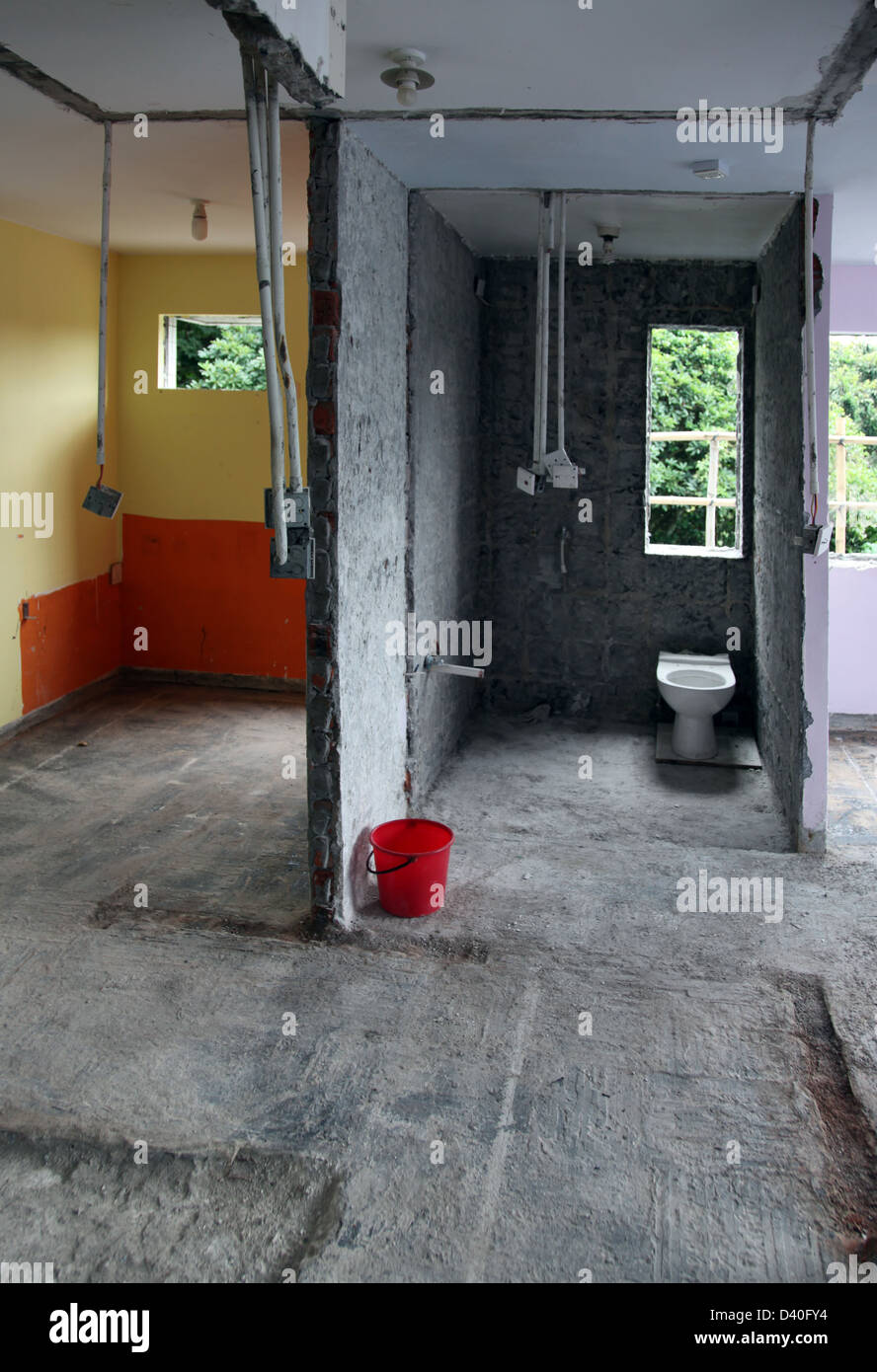 It's a photo of a house which is refurbished. We can see the work in progress with the non-finished stairs, steps, wall, rooms Stock Photo