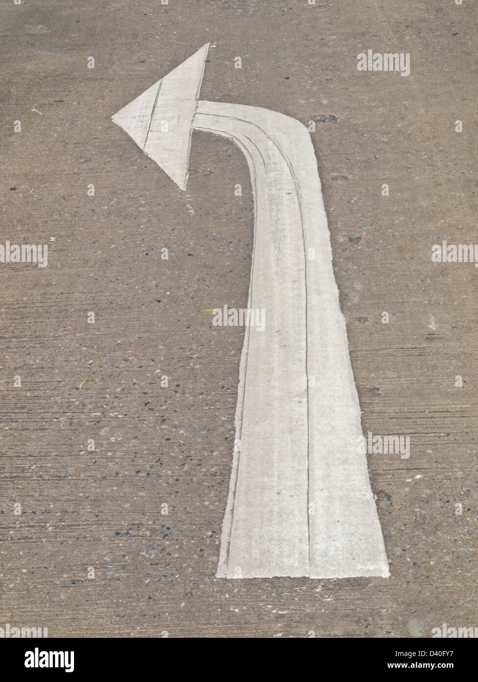 Turn left white arrow on road pavement as background Stock Photo