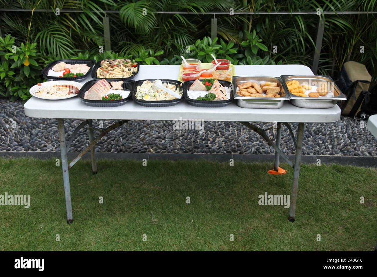 It's a photo of an outdoor table full of food for a buffet or a