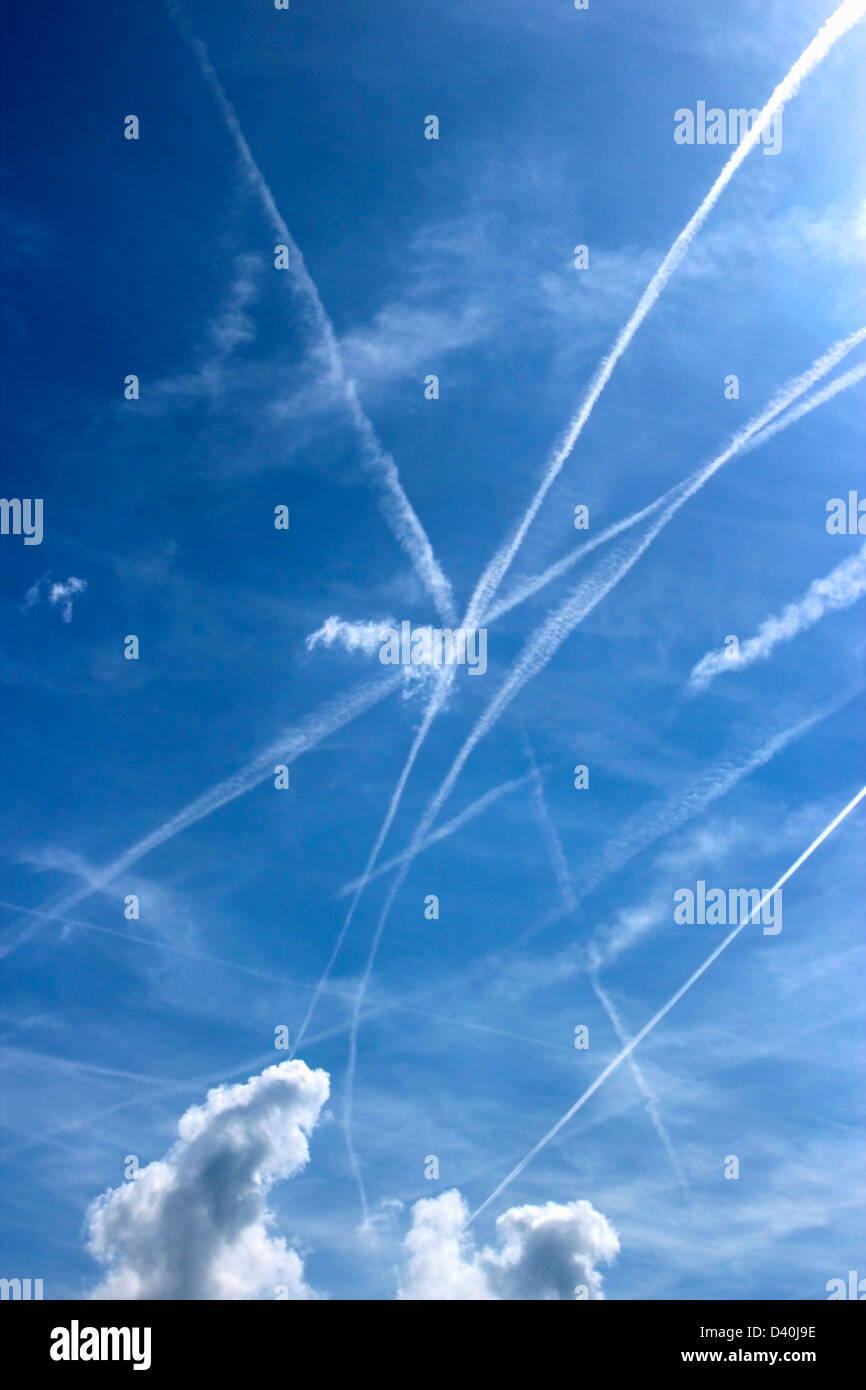 Plane trails on blue sky, portrait Stock Photo