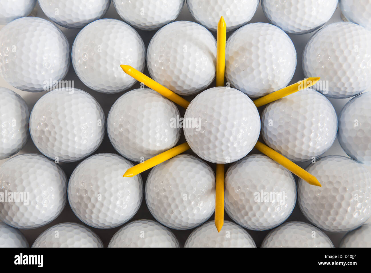 White golf balls and yellow tees Stock Photo Alamy