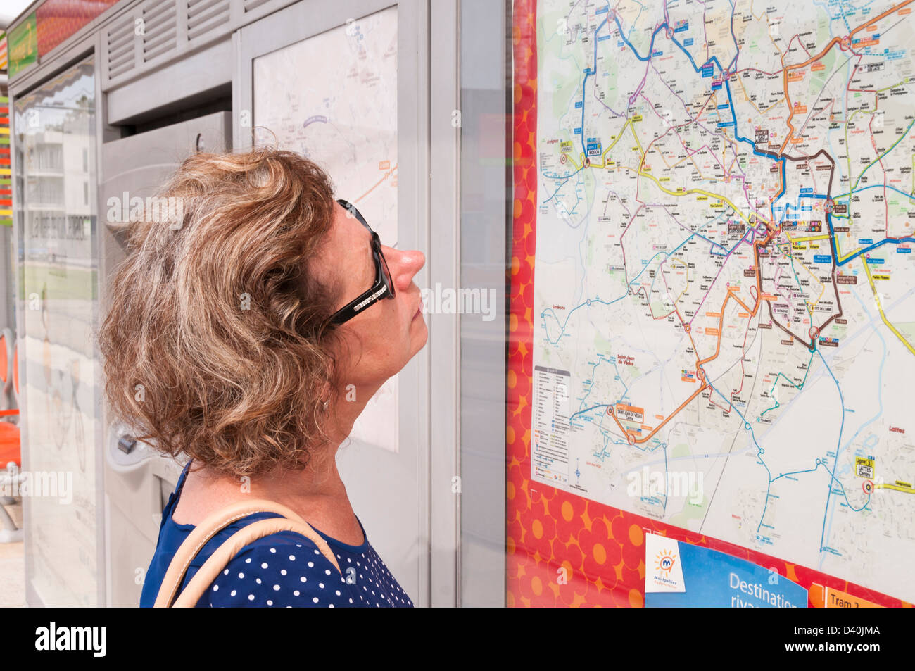 Woman looking at map of tramway, Montpellier, Hérault, Languedoc-Roussillon, France Stock Photo
