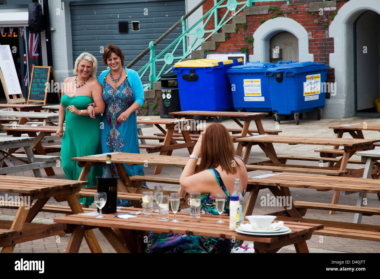 Women celebrate in a beach front restaurant in Brighton, England Stock Photo