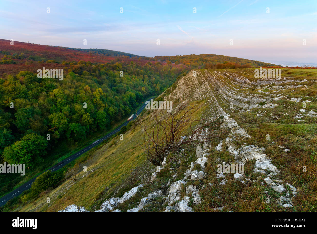 The Coombe above Burrington Coombe in the Mendip hills, Somerset with light traffic traveling on the B3134 in below the hills. Stock Photo