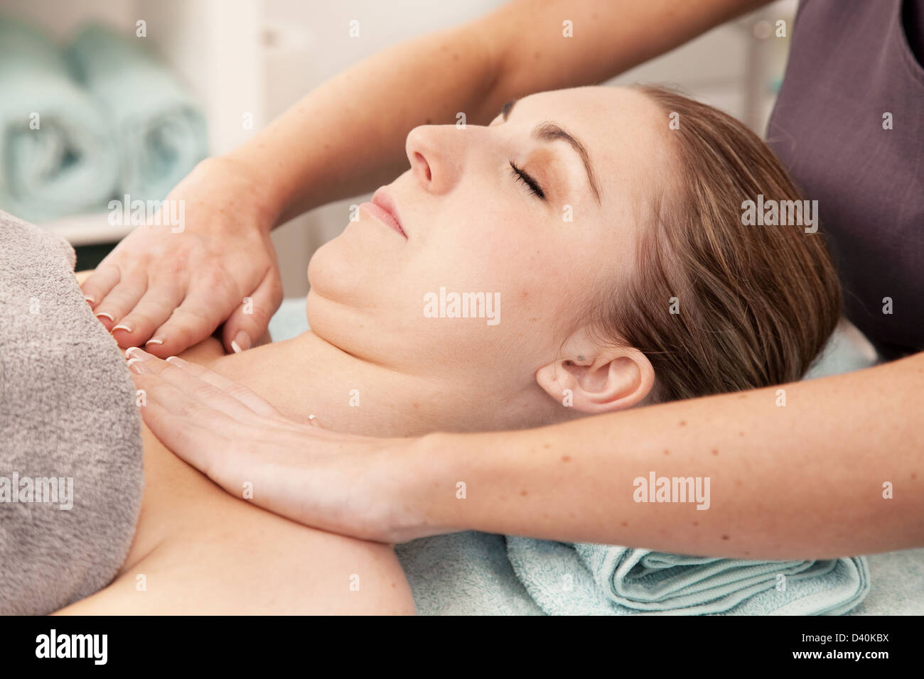 Masseuse massages the neck & shoulders of a woman - Stock Image - M740/0395  - Science Photo Library