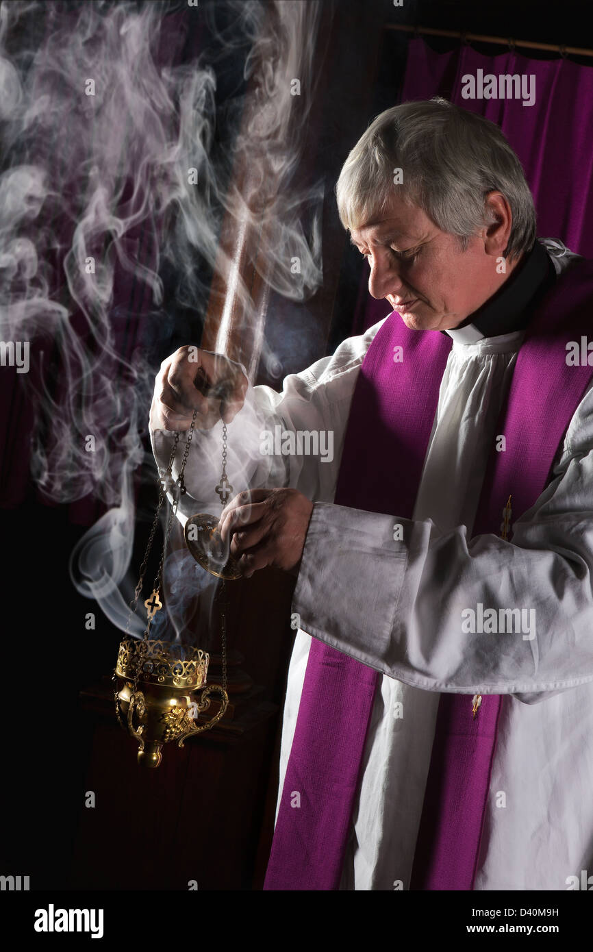 Incense in a burner and catholic priest Stock Photo Alamy