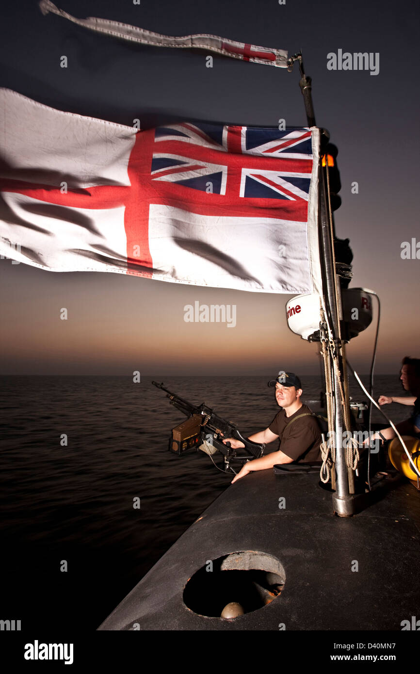 White Ensign with guard and 7.62mm machine gun on Nuclear Submarine HMS Talent, Egypt Stock Photo