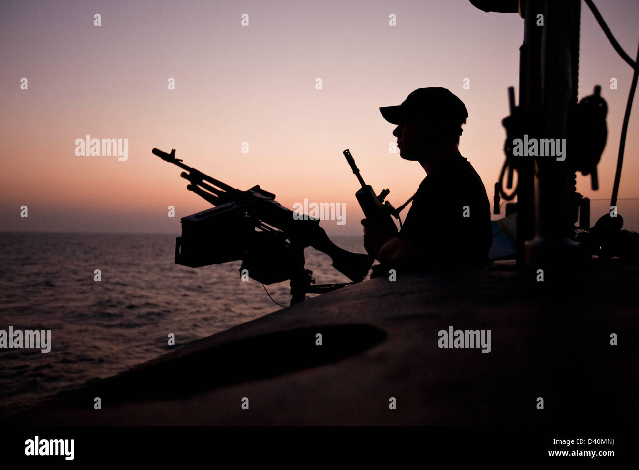 Guard on deck of Nuclear Submarine HMS Talent with machine gun Stock Photo