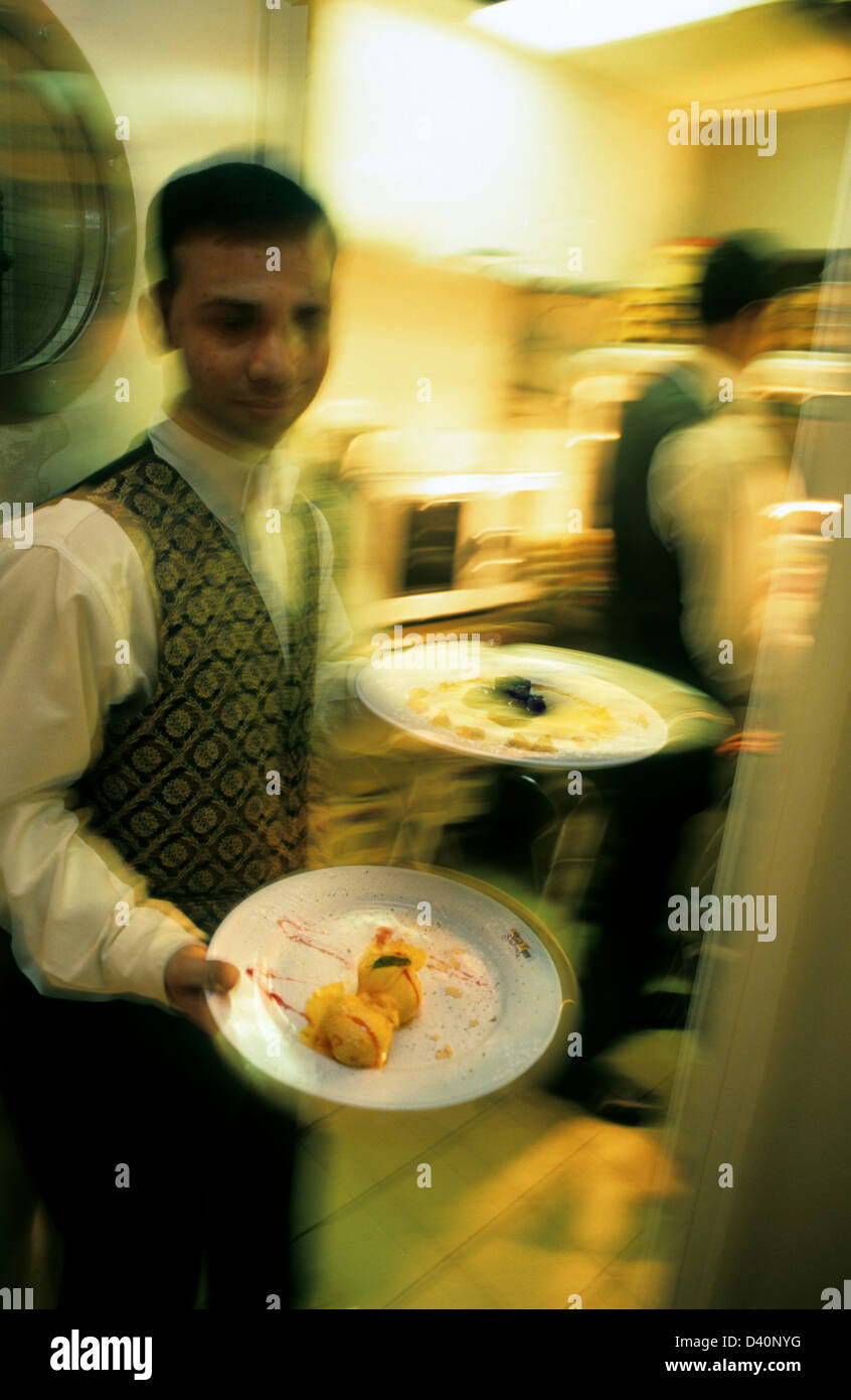 A busy waiter in an Indian restaurant. Stock Photo