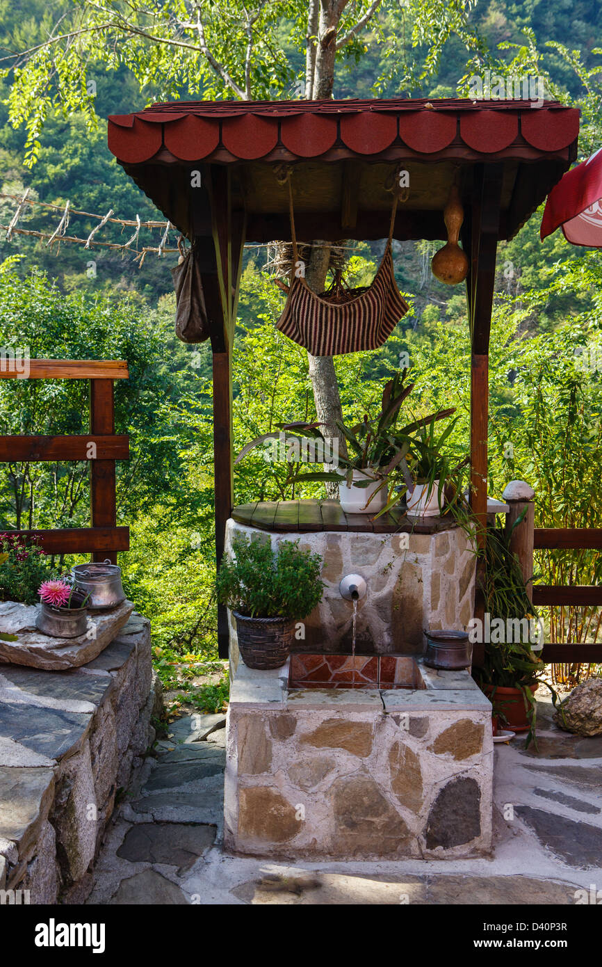 Source of mineral water in an internal court yard of restaurant in mountains Stock Photo