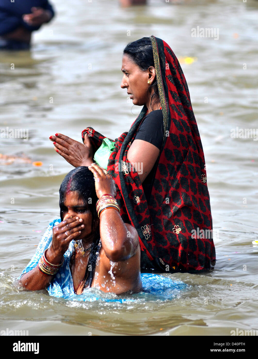 Women devotees gathered to take a holy dip at the bank of Sangam confluence of river Ganga, Yamnuna and mythical Saraswati . Stock Photo