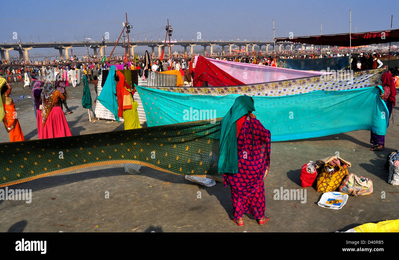 Women devotees dries saris near the Sangam, in the Kumbh Mela area on February 9, 2013 in Allahabad, India. Stock Photo