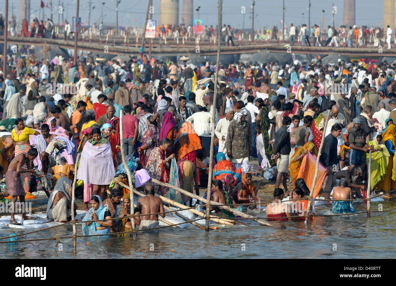 Hindu pilgrims take bath on the banks of Sangam, the confluence of the holy rivers Ganges, Yamuna and the mythical Saraswati, Stock Photo