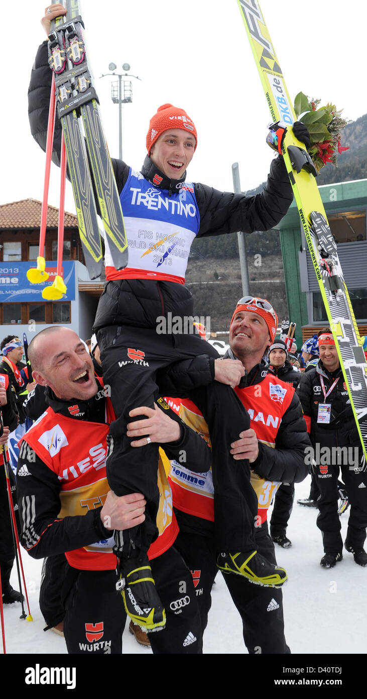 Two ski technician carry Eric Frenzel on their shoulders after the