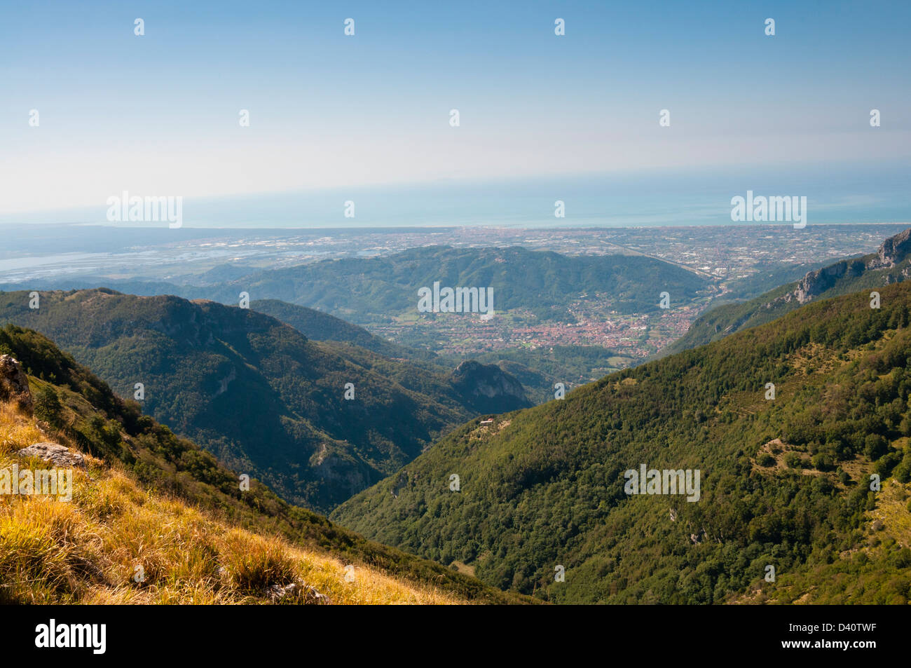 View of Camaiore city and Tyrrhenian sea from Apuan Alps (Alpi Apuane), Lucca Province, Tuscany, Italy Stock Photo