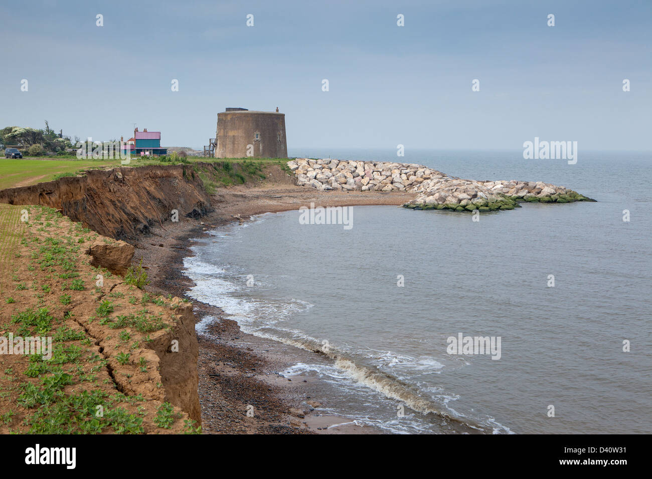 Martello Tower at Bawdsley Suffolk on the suffolk, England coastline, showing  coastal erosion and riprap rock protection Stock Photo