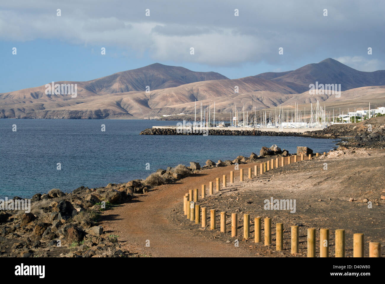 footpath between puerto del carmen and puerto calero with femes mountains  in the distance lanzarote canary islands spain Stock Photo - Alamy