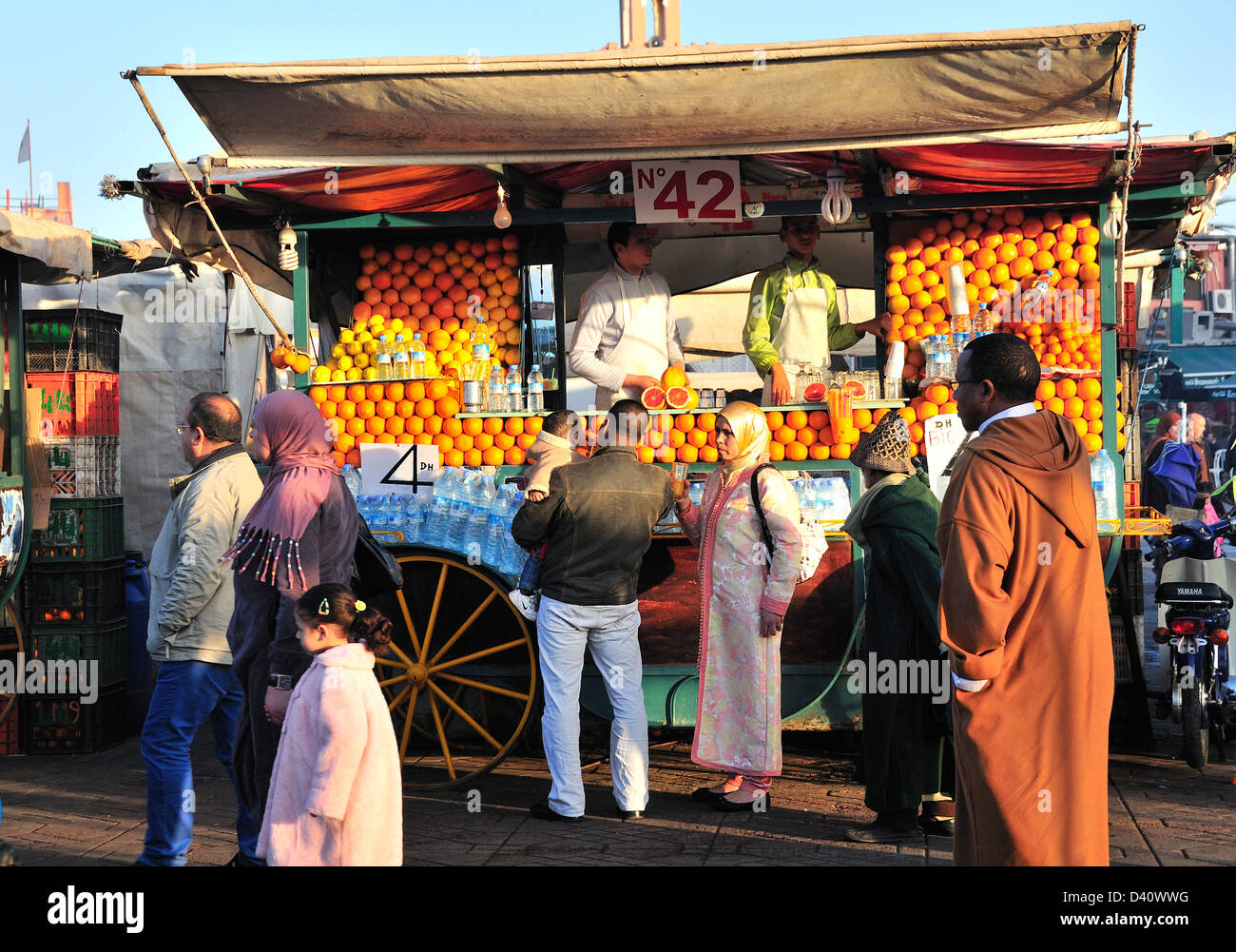 Locals in front of an orange juice seller in Jemaa El Fna ...