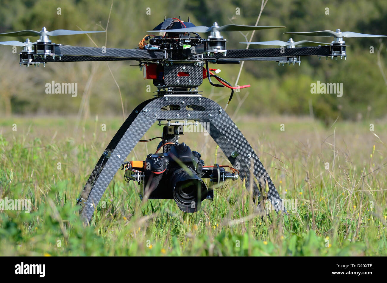 Drone and digital camera on an Unmanned Aerial Vehicle (UAV or Drone), with six rotors, used here for aerial photography or filming Stock Photo