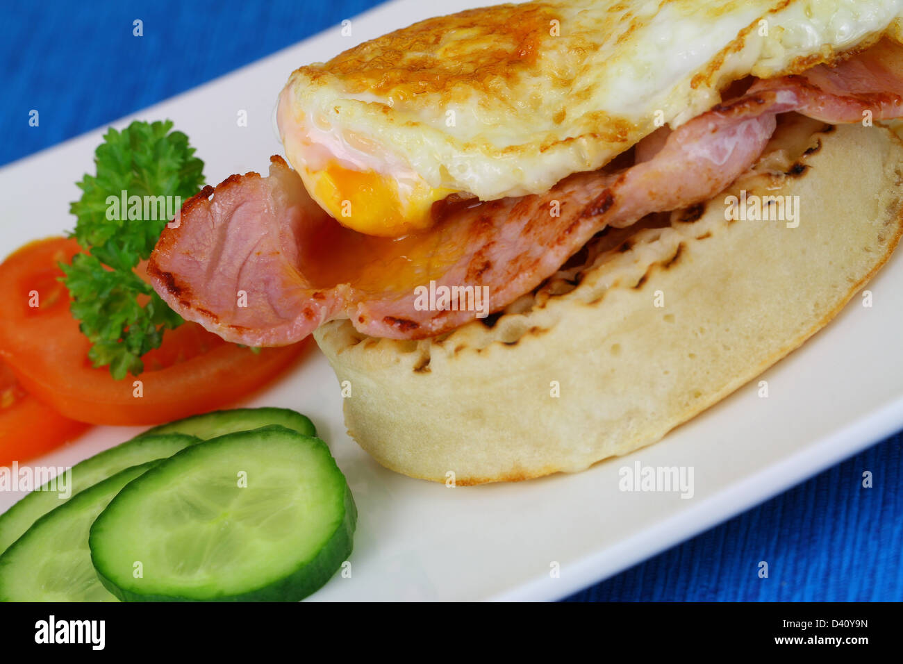 Crumpet with bacon and fried egg Stock Photo