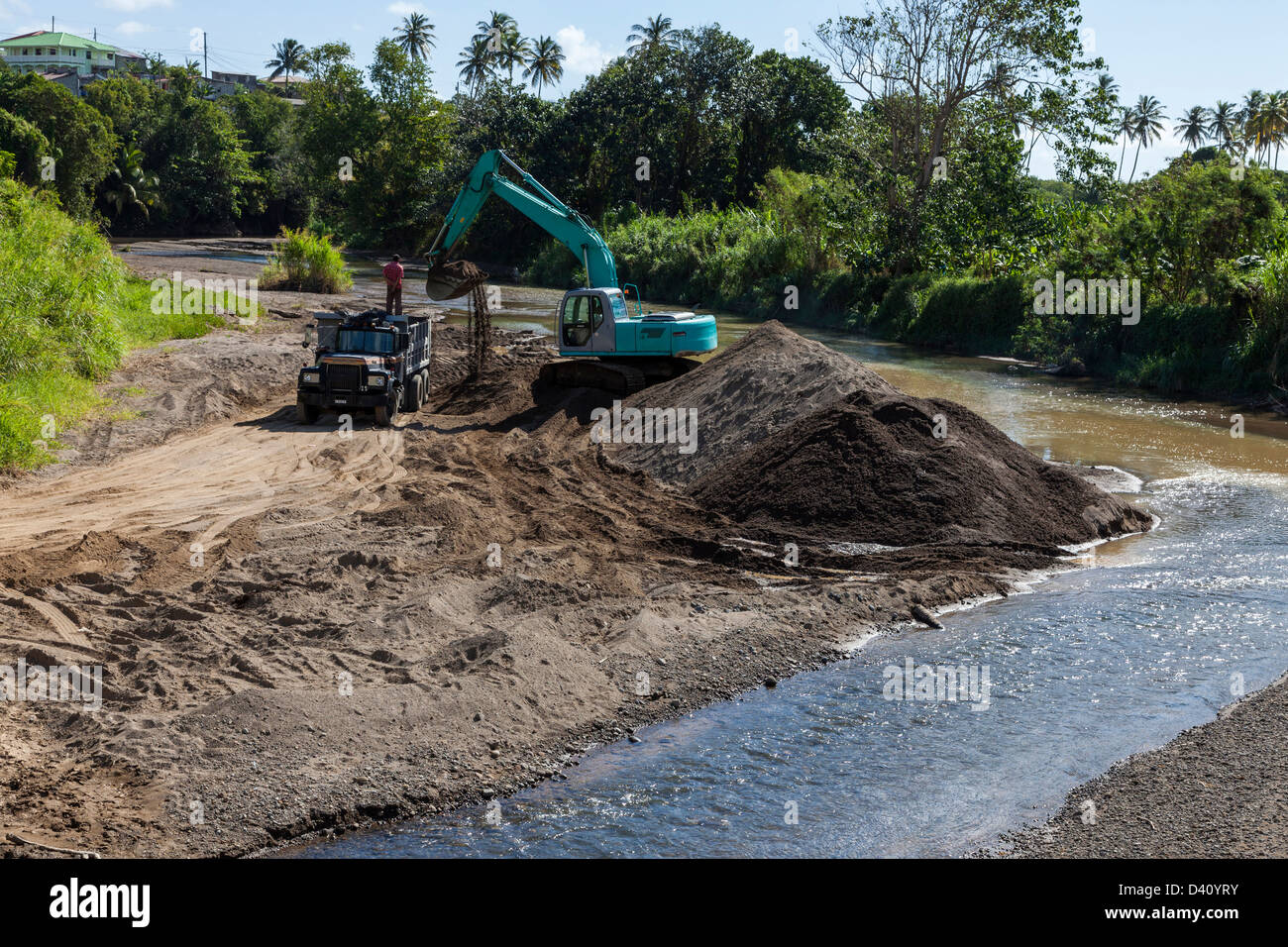 Digger removing gravel from a river bed, Micoud, St Lucia Stock Photo