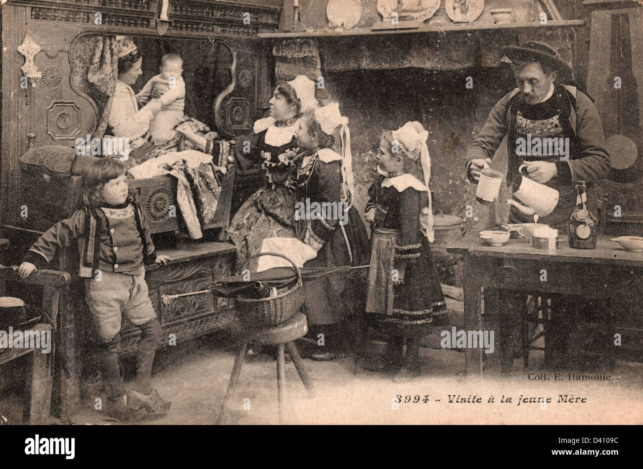 Old black and white french postcard - The visit to the young mother - Brittany, France Stock Photo