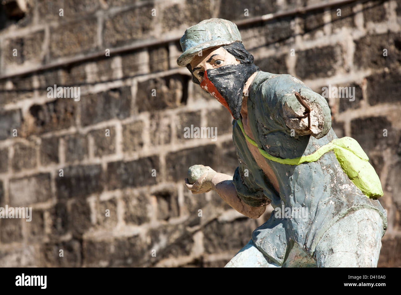 A statue of a masked sandinista fighter throwing something in protest in Leon Nicaragua Stock Photo