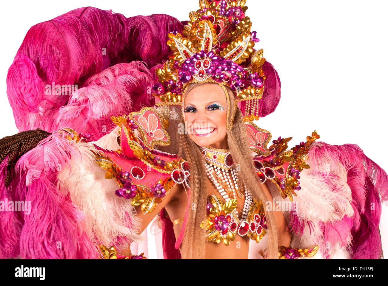 Portrait of young woman in pink carnival costume, close up against white background Stock Photo