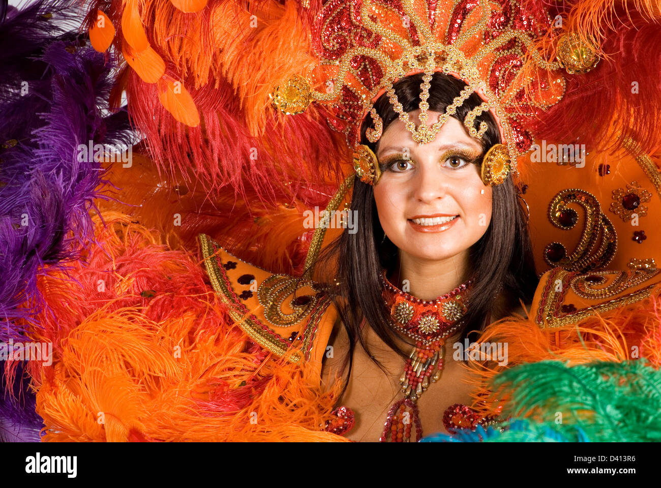 Portrait of young woman in colorful carnival costume, close up Stock Photo