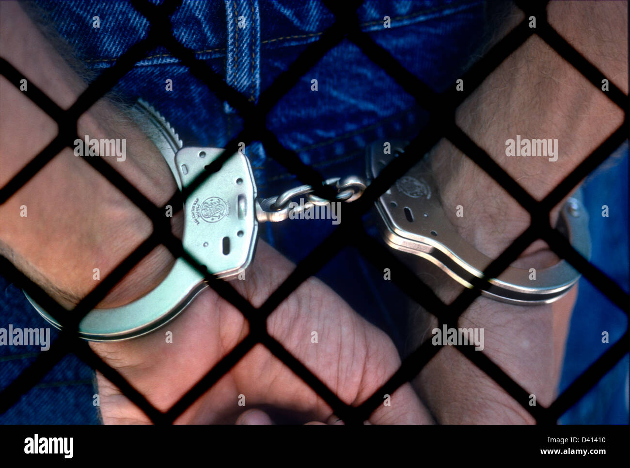 man-with-hands-handcuffed-behind-chain-l