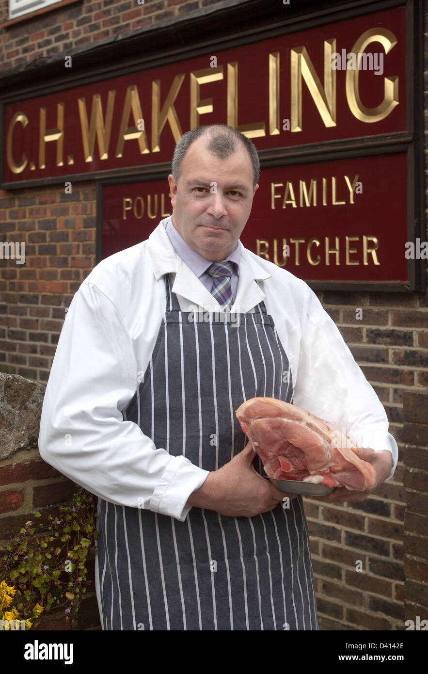 Roger Wakeling Butcher with Cut of Meat outside his shop in