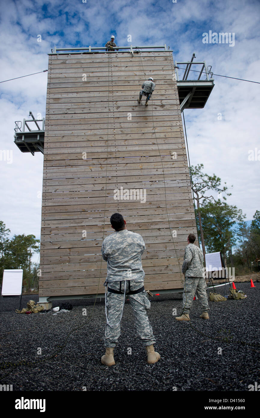 US Green Beret Special Forces soldiers run down a 40-foot training tower during rappelling training February 4, 2013 at Eglin Air Force Base, Florida. Green Berets practiced descending a 40-foot rope and a 40-foot rappelling wall. Stock Photo