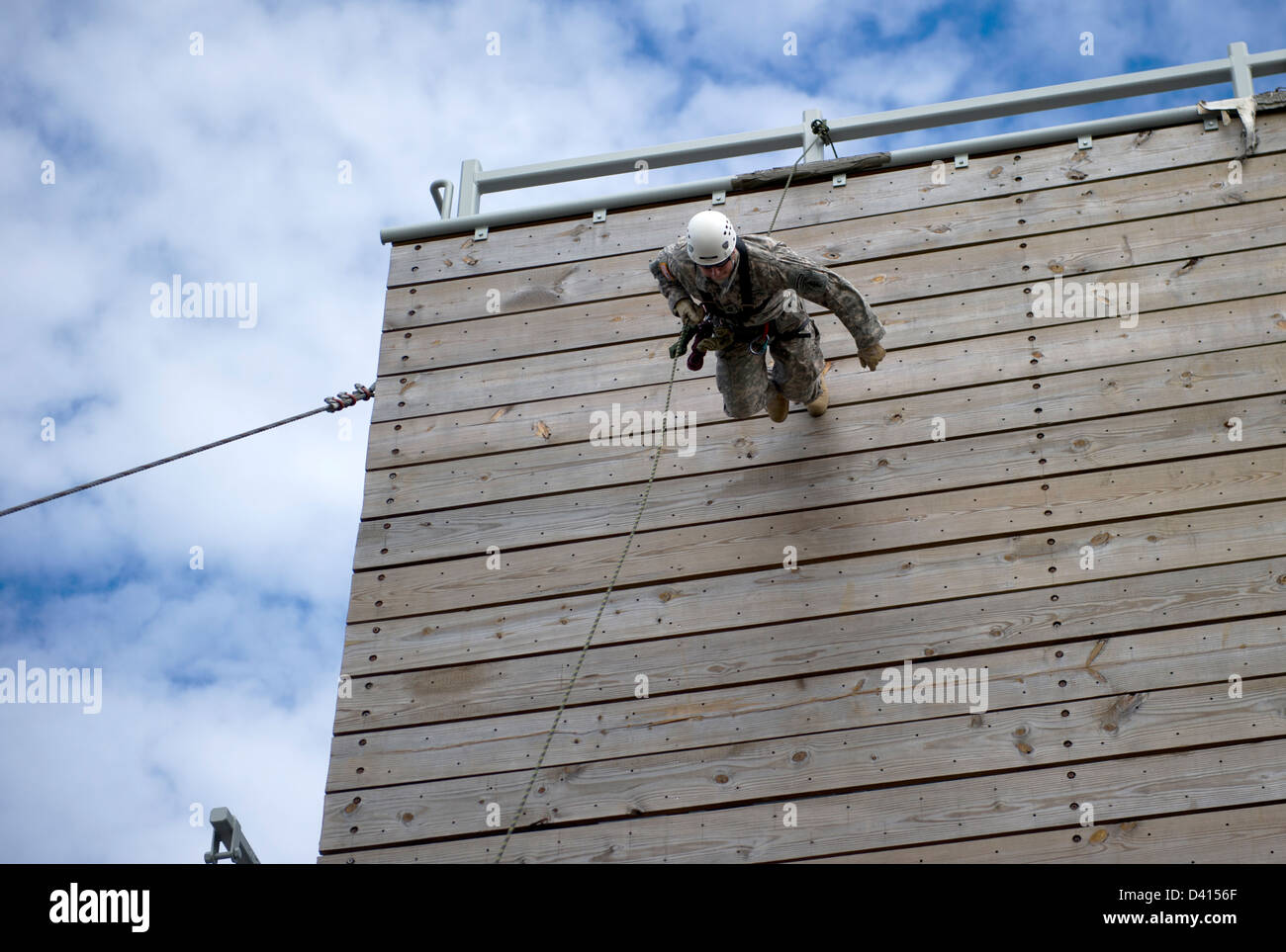 US Green Beret Special Forces soldiers runs down a 40-foot training tower during rappelling training February 4, 2013 at Eglin Base Air Force Base, Florida. Green Berets practiced descending a 40-foot rope and a 40-foot rappelling wall. Stock Photo