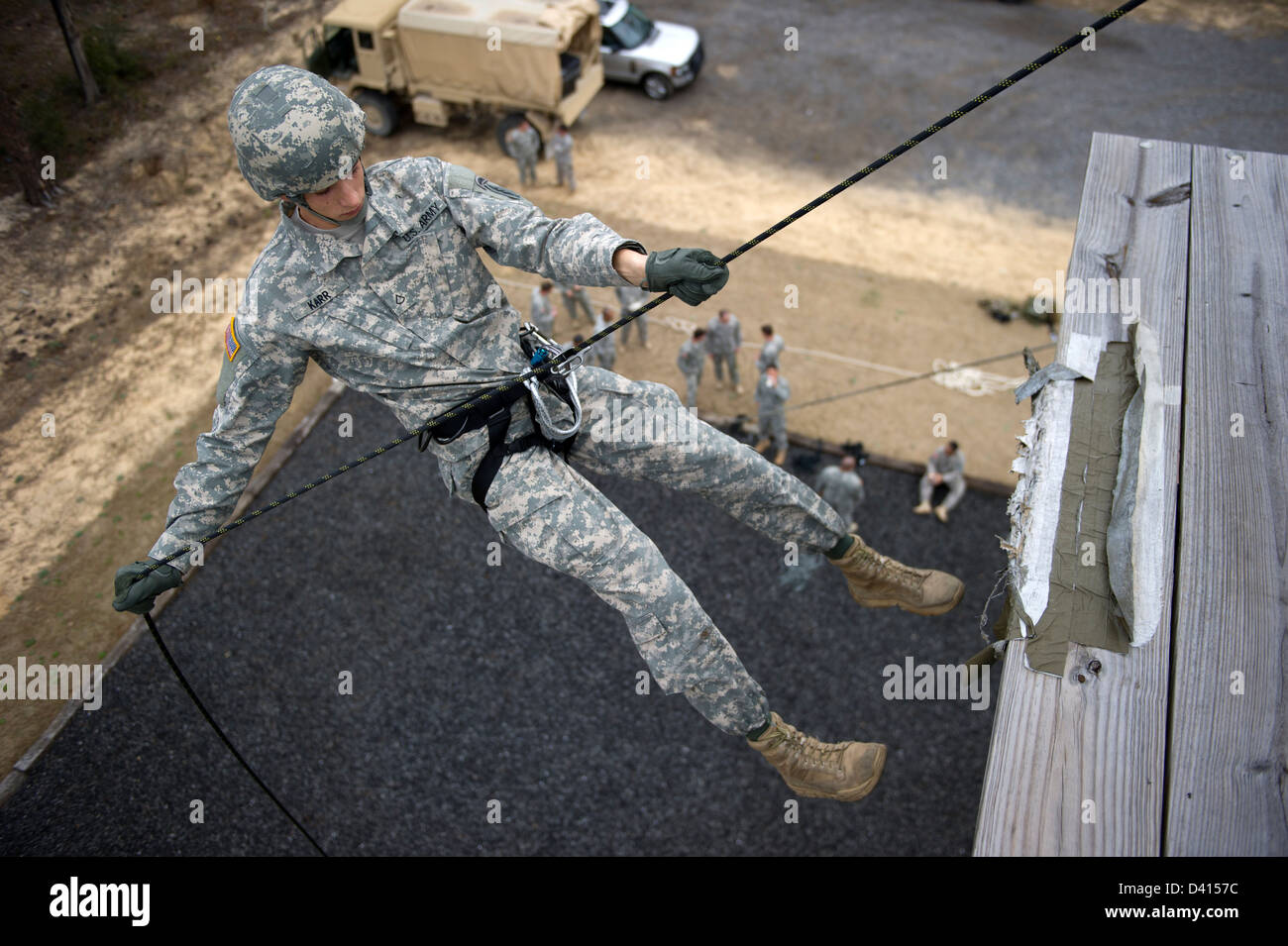 US Green Beret Special Forces soldiers starts to rappel down a 40-foot training tower February 4, 2013 at Eglin Base Air Force Base, Florida. Green Berets practiced descending a 40-foot rope and a 40-foot rappelling wall. Stock Photo
