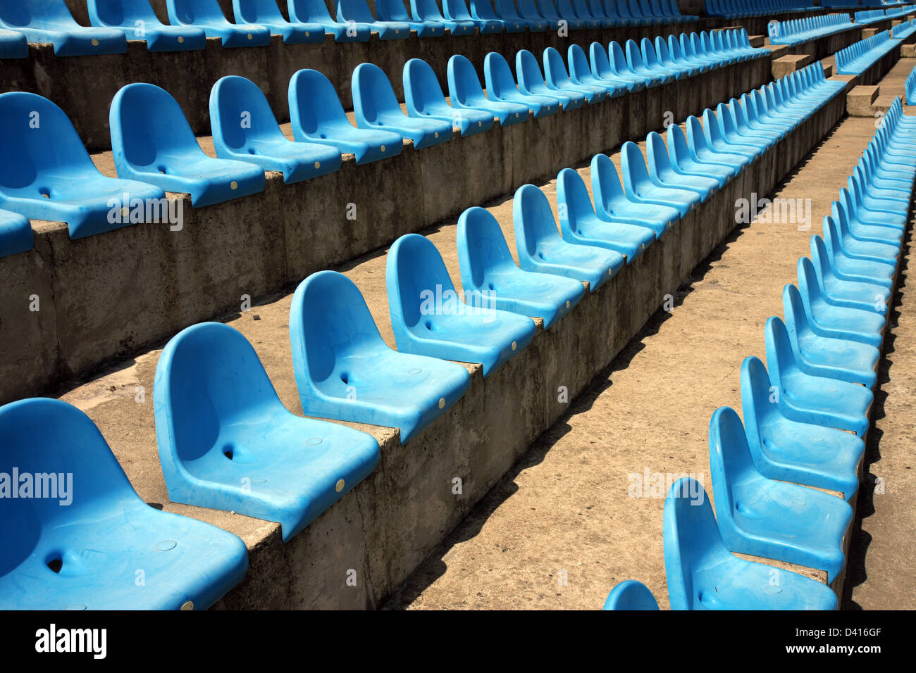 blue plastic empty seats on football stadium Stock Photo