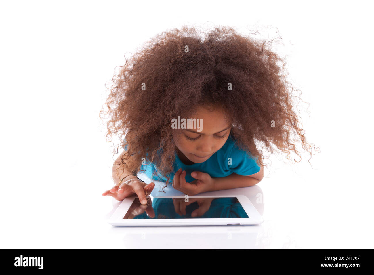 Little african asian girl using a tablet pc, isolated on white ...