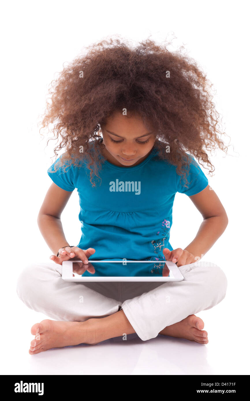 Little african asian girl using a tablet pc, isolated on white ...