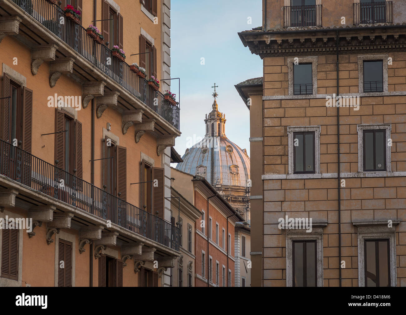 Sant Andrea della Valle lit up by setting sun and seen through streets from Piazza Navona Stock Photo