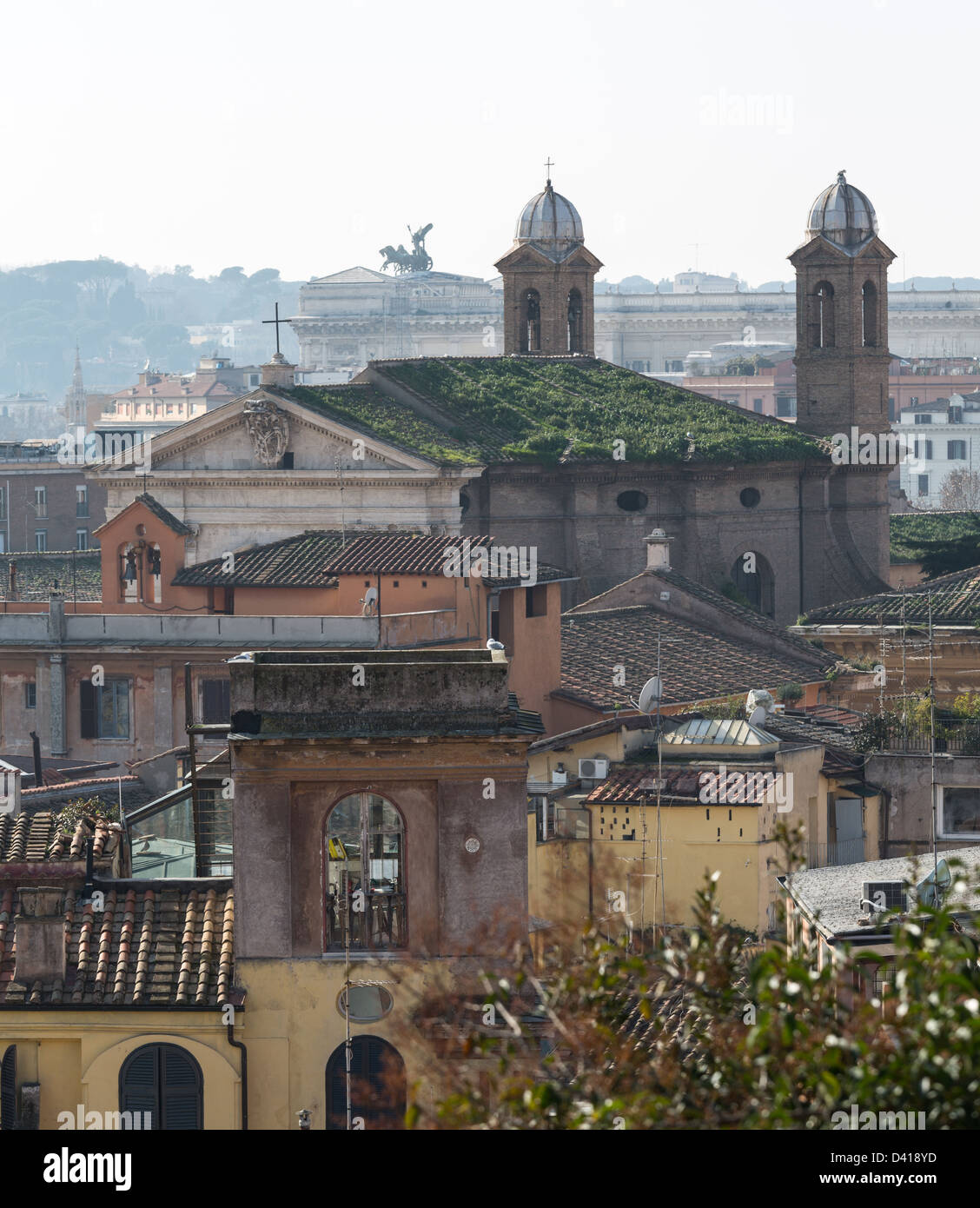 Basilica church with grass on roof in the skyline of Rome Italy with smog in the distance Stock Photo