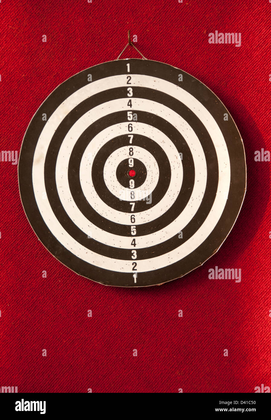 Dart board in red background Stock Photo