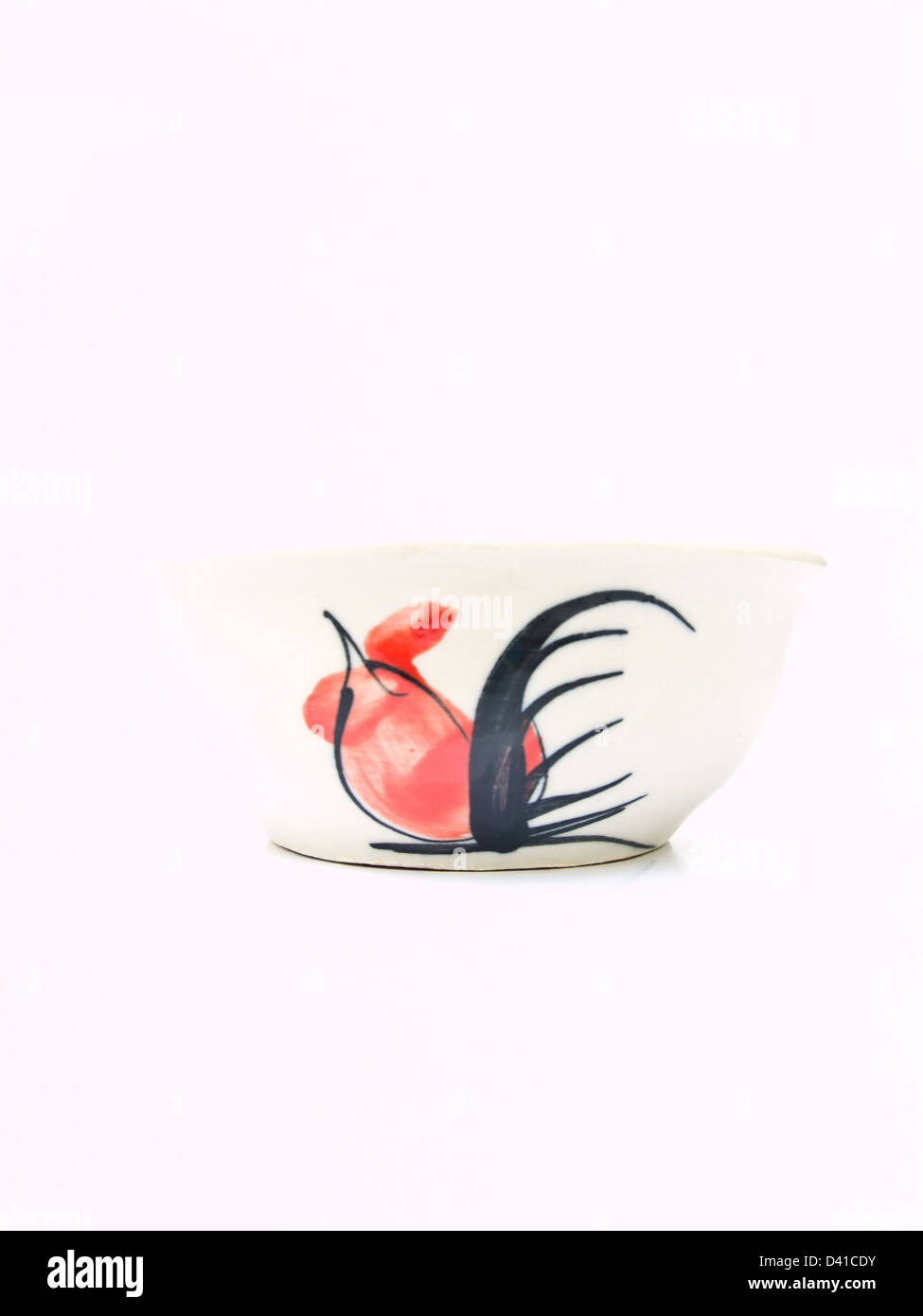 A white ceramic bowl with a chicken pattern from Lampang, Thailand