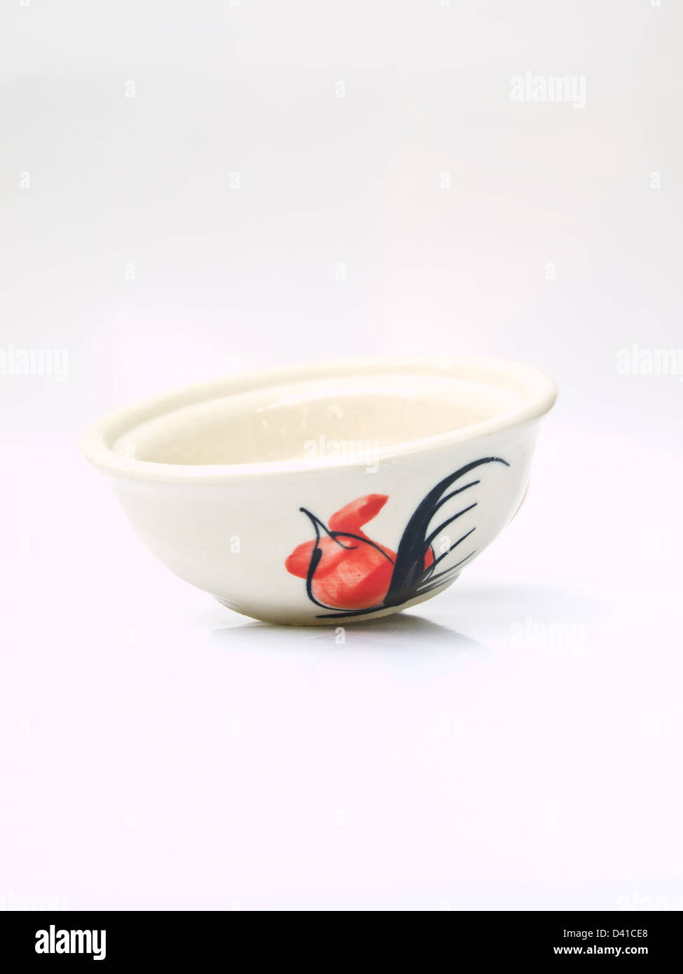 A white ceramic bowl with a chicken pattern from Lampang, Thailand