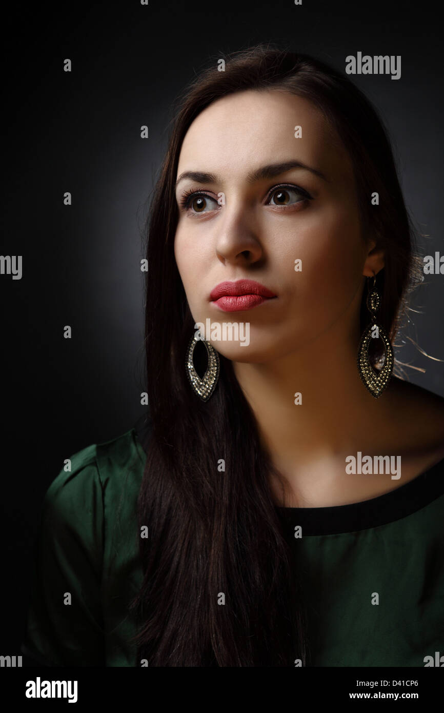 studio shot: portrait of a young beautiful woman on black background ...