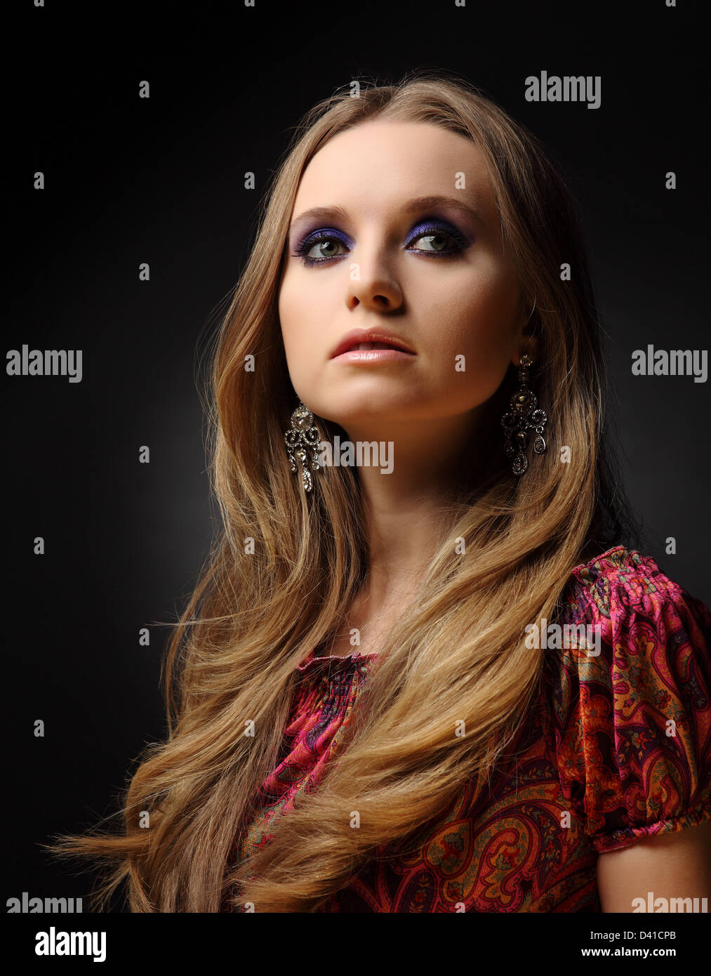 studio shot: portrait of a young beautiful woman on black background ...