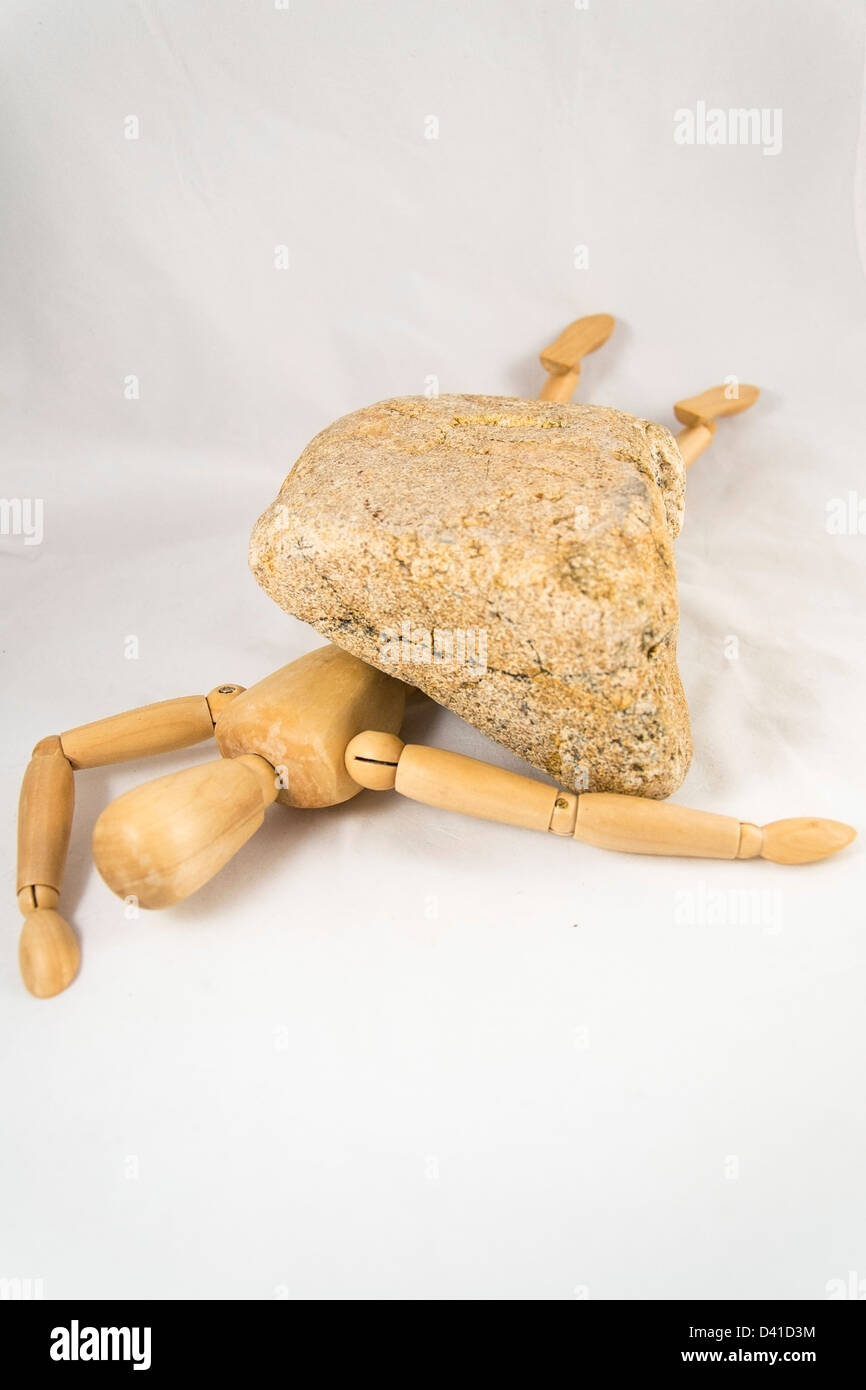 Dummy crushed by rock. Dangerous life Stock Photo