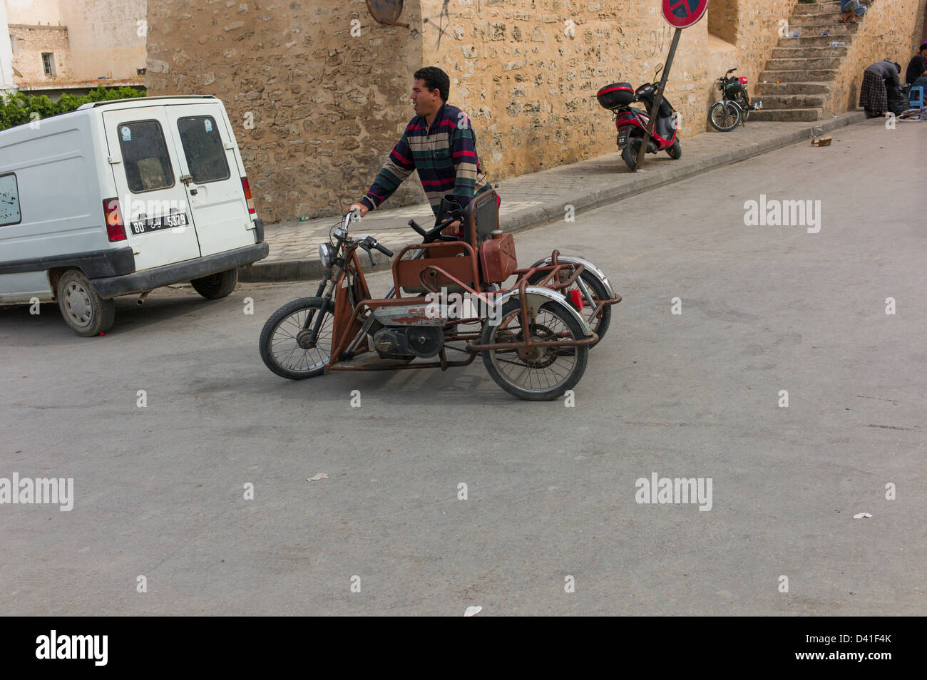 Man with 3 wheel motorcycle for disabled person in Sousse Tunisia Stock Photo
